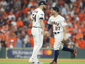 Astros pitcher Roberto Osuna, left, celebrates with Jose Altuve after defeating the Rays in Game 1 of the American League Division Series at Minute Maid Park in Houston, on Friday, Oct. 4, 2019.