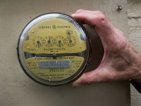 Howie Harrington with his old meter outside his home in North Vancouver. Harrington had refused a smart meter in 2013, and has been paying B.C. Hydro about $34 a month to retain his legacy meter. But now B.C. Hydro is telling him he has to switch to a smart meter with a "radio off" feature, which he still has to pay $20 a month for plus an installation fee.