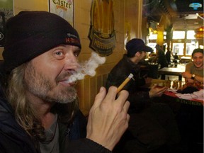 FILE PHOTO: Sitting in the designated smoking room of the Cambie Pub patron Chris Dittmann speaks about the new B.C. tobacco law that takes effect mar.31/08 requires all indoor public and work places to be smoke-free. March 31, 2008.