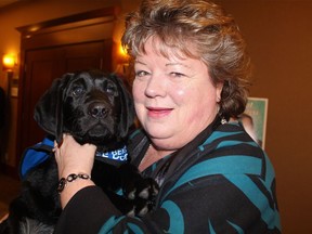 Richmond MLA Linda Reid with Toby, an autism support dog in training, at a charitable event in January.