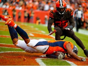 Wide receiver Courtland Sutton #14 of the Denver Broncos catches a touchdown pass as safety Jermaine Whitehead #35 of the Cleveland Browns defends on the play during the first quarter at Broncos Stadium at Mile High on November 3, 2019 in Denver, Colorado.