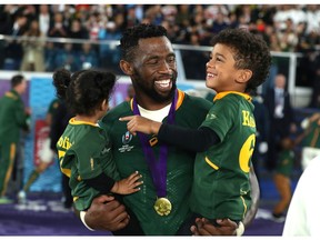 YOKOHAMA, JAPAN - NOVEMBER 02: Siya Kolisi of South Africa shares a laugh with his children during the Rugby World Cup 2019 Final between England and South Africa at International Stadium Yokohama on November 02, 2019 in Yokohama, Kanagawa, Japan.