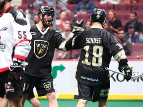 Logan Schuss of the Warriors is congratulated after scoring one of two goals against the Calgary Roughnecks on Friday at Rogers Arena in Vancouver. Calgary won 12-7.