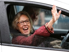 Elizabeth May waves to supporters after voting in Sidney on Oct. 21.