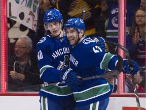 Sven Baertschi, right, will get another chance to celebrate goals with Elias Petterson as he was recalled by the Vancouver Canucks from Utica, N.Y.