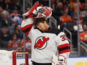 New Jersey Devils goalie Cory Schneider makes a funny face as he pulls his mask on to face the Oilers at Rogers Place in Edmonton on Nov. 8.