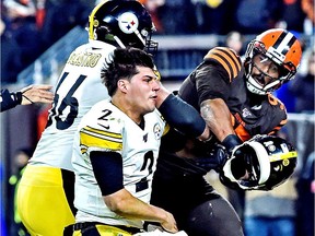 Cleveland Browns defensive end Myles Garrett (95) hits Pittsburgh Steelers quarterback Mason Rudolph (2) with his own helmet as offensive guard David DeCastro (66) tries to stop Garrett during the fourth quarter at FirstEnergy Stadium.