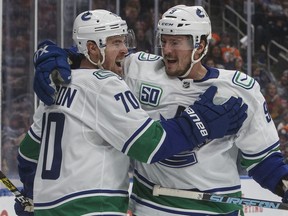 Canucks' Tanner Pearson (70) and J.T. Miller (9) celebrate the first of Pearson's two goals against the Edmonton Oilers, in Edmonton, Saturday.