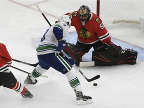 Vancouver Canucks center J.T. Miller (9) skates with the puck as Chicago Blackhawks goaltender Corey Crawford (50) defends during the first period at United Center.