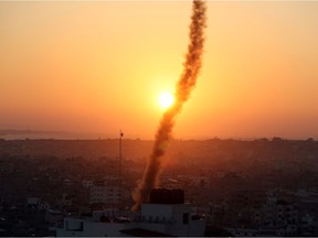 A trail of smoke can be seen as rockets are fired from Gaza towards Israel during the sunrise, in Gaza November 12, 2019. REUTERS/Mohammed Salem