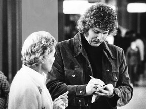 Gary 'Suitcase' Smith, goaltender for the Vancouver Canucks, signs an autograph for an admiring fan after his 2-1 victory over the Montreal Canadiens. This was the first win over Montreal in Canucks franchise history and it tied the quarter final playoff series at one game each.