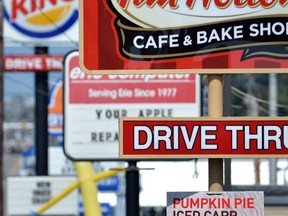 Fast food restaurant signs are shown in Erie, Pa. on Aug. 26, 2014.