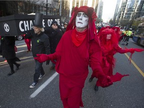 Supporters of the Extinction Rebellion movement take part in a protest and funeral march for the environment Friday, November 29, 2019 in downtown Vancouver, BC.