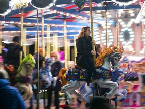 VANCOUVER, B.C.: DECEMBER 17, 2018 -- Victoria Duffield goes on the carousel ride while visiting the VanDusen Gardens 2018 Festival of Lights in Vancouver, BC, December, 17, 2018.