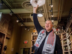 CFL commissioner Randy Ambrosie yahoos with his official Calgary white hat for the Grey Cup after Tourism Calgary's Cindy Good swore him in with the official white-hat oath at Lammle's Western Wear shop on Nov. 18, 2019.