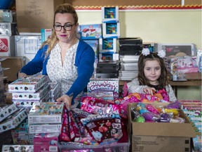 Maria Aranda and her daughter Bianca set up the toy room at the Salvation Army in New Westminster on Tuesday. The Aranda family receives help from the Salvation Army and she volunteers as a way of giving back.