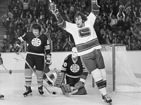 Canucks winger Ron Sedlbauer celebrates after scoring against Boston Bruins goalie Dave Reece while defenceman Brad Park — in his first game as a Bruin after a blockbuster trade from the New York Rangers — looks on during a Nov. 10, 1975 NHL game at the Pacific Coliseum.