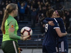 UBC Thunderbird Natasha Klasios, right, congratulates teammate Danielle Steer for scoring what proved to be the game-winning goal against University of Calgary Dinos goalkeeper Lauren Houghton during the 2019 U Sports Women's Soccer Championship final in Victoria.