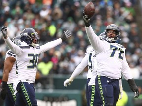 Al Woods #72 and Bradley McDougald #30 of the Seattle Seahawks react after a fumble recovery against the Eagles at Lincoln Financial Field on Nov. 24 in Philadelphia.