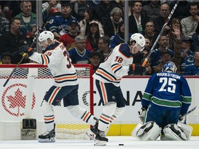 Alex Chiasson and James Neal of the Edmonton Oilers celebrate a goal by Leon Draisaitl