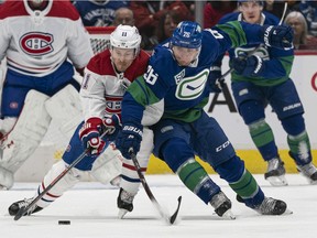 Brendan Gallagher, left, of the Montreal Canadiens and Antoine Roussel of the Canucks battle for the puck during NHL action at Rogers Arena on Dec. 17, 2019, in Vancouver.