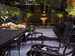 A Parisian-style garden, with limited plant palette but atmospheric lighting and seating, is surrounded by privacy fencing and forms an inviting corner of the backyard. (Photo courtesy of Plantenance, to illustrate Jennifer Cox's piece in the Gazette's New Homes & Condos section)
