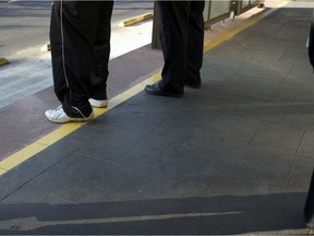 Legs of eople waiting for a bus. Getty Images stock pic. For 1222 cp bus impacts [PNG Merlin Archive]