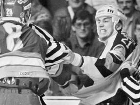 Cam Neely tangles with a Calgary Flame during his time with the Vancouver Canucks in the early 1980s. Neely would take his rugged, but skilled game on to Boston, where he carved out a Hall of Fame career.