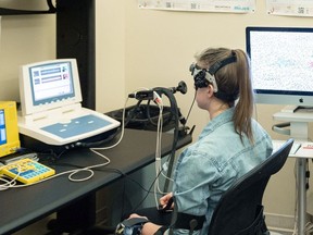 A research trainee is seen during a demonstration of the measurement of blood flow to the brain through transcranial doppler ultrasound at the University of British Columbia's Okanagan campus, in Kelowna. The ultrasound is one way UBC scientists are looking for evidence of traumatic brain injury in survivors of intimate partner violence.