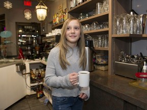 Gia Carella serves a coffee at the Cozmos Cafe in Burnaby.