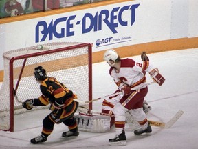 Canucks captain Stan Smyl (left) is foiled by another save by Calgary Flames goalie Mike Vernon with defenceman Al MacInnis giving Smyl the stick at Calgary's Olympic Saddledome during their epic 1988-89 Stanley Cup playoff series, a tilt the Flames won in seven games.