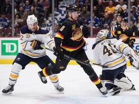Vancouver Canucks' centre Elias Pettersson crashes into the Buffalo net on Saturday afternoon while competing for the puck with the Sabres' Johan Larsson in front of goalie Carter Hutton. The Canucks won 6-5 in overtime.
