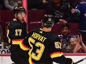 Vancouver Canucks forward Josh Leivo, who scored twice Saturday afternoon against the Buffalo Sabres at Rogers Arena, celebrates his first goal with teammate Bo Horvat.