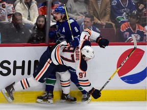 Canucks defenceman Chris Tanev defends against Edmonton Oilers forward Connor McDavid during the third period at Rogers Arena.
