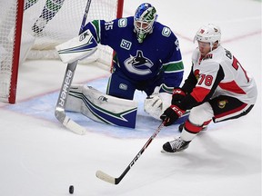 Ottawa Senators forward Filip Chlapik reaches for the puck against Vancouver Canucks goaltender Thatcher Demko during the second period at Rogers Arena on Sept. 25, 2019.