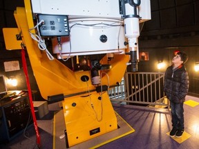 Jose Valdes Rodriguez, who says he wants to be an astronomer and help guide space missions, casts his eyes on the observatory telescope at the University of Victoria's Bob Wright Centre.