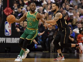 Celtics guard Kemba Walker (left) dribbles the ball past Raptors guard Fred VanVleet (right) during first half NBA action at Scotiabank Arena in Toronto, Wednesday, Dec 25, 2019.