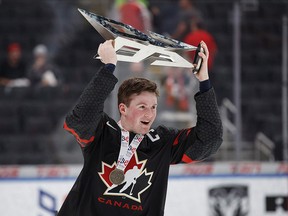 Canada's Alexis Lafreniere (11) hoists the Hlinka Gretzky Cup following the gold medal game against Sweden in Edmonton on Saturday, August 11, 2018. (THE CANADIAN PRESS/Codie McLachlan)