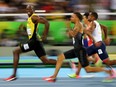 Usain Bolt of Jamaica looks at Andre De Grasse of Canada as they compete in the 2016 Rio Olympics, Men's 100m Semifinals at the Olympic Stadium in Rio de Janeiro, Brazil, August 14, 2016. Picture taken August 14, 2016.