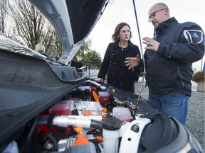 Automotive service technician Manoli Paterakis shows Minister of Energy, Mines and Petroleum Resources Michelle Mungall an electric engine after Mungall announced the new electric vehicle training program will be available to the public starting in 2020, at a news conference at Vancouver city hall on Dec. 4, 2019.