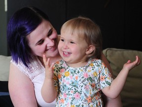 One-year-old Charlie Lock, who is allergic to the sun, with her mother Bekah in Langley in July.