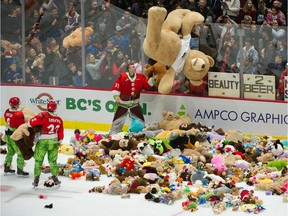 Goalie Trent Miner watches a giant teddy bear being heaved over the glass after Michal Kvasnica scored to set off the flinging of the bears during the annual Teddy Bear Toss game between the Vancouver Giants and the Tri-City Americans at Rogers Arena in Vancouver on Dec. 8.