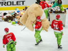Tristen Nielsen of the Vancouver Giants carries a giant stuffed toy off the ice on Sunday at Rogers Arena in the team’s annual Teddy Bear Toss game. Nielsen and his teammates will have to carry an even bigger load for the next eight games as all-star defenceman Bowen Byram heads to the Team Canada world junior tryout camp.