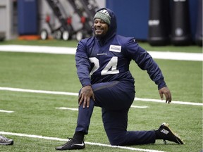 Seattle Seahawks running back Marshawn Lynch stretches during warmups at the NFL football team's practice facility on Tuesday in Renton, Wash.