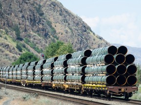 Pipes destined for the Trans Mountain pipeline are transported by rail through Kamloops in June 2019.