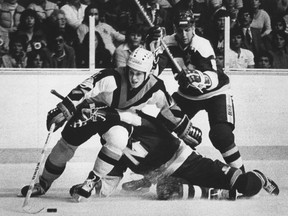 A determined Canucks centre Patrik Sundstrom breaks out of the clutches of Minnesota defenceman Brad Maxwell (standing) and an unidentified fallen North Stars defender on Oct. 7, 1983 at the Pacific Coliseum. Sundstrom scored twice as the Canucks won a 10-9 shootout over the North Stars.
