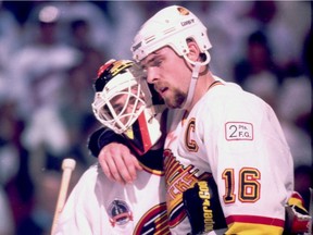 Relief! Goalie Kirk McLean gets a huge hug, THAT hug, from Trevor Linden after the Canucks' 4-1 win over the New York Rangers in Game 6 of the Stanley Cup Finals at the Pacific Coliseum. 'The picture really does tell the story,' says McLean. 'We kind of hugged it out. He’s got the blood on his jersey and my mask was halfway around my face from his hug.'