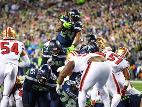 Seattle Seahawks' Marshawn Lynch leaps and scores a touchdown during Sunday's game against the San Francisco 49ers. (GETTY IMAGES)