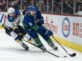 Zach Sanford of the St. Louis Blues can't keep up with Canucks' defenceman Chris Tanev during NHL action at Rogers Arena on Nov. 5, 2019. Tanev has remained healthy this season as his team spends less time stuck in its own end blocking shots.