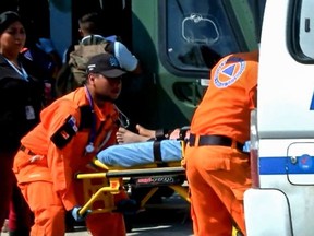 Grab taken from Panamanian channel TVN Noticias showing Panamanian paramedics carrying one of the 15 people rescued from a religious sect on a stretcher in Santiago, Veraguas province, Panama on January 15, 2020.